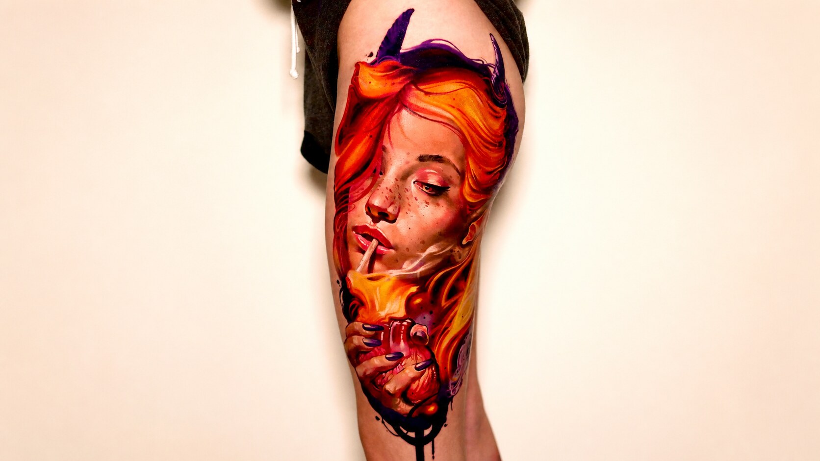 Color realism tattoo of a red-haired woman framed by flames