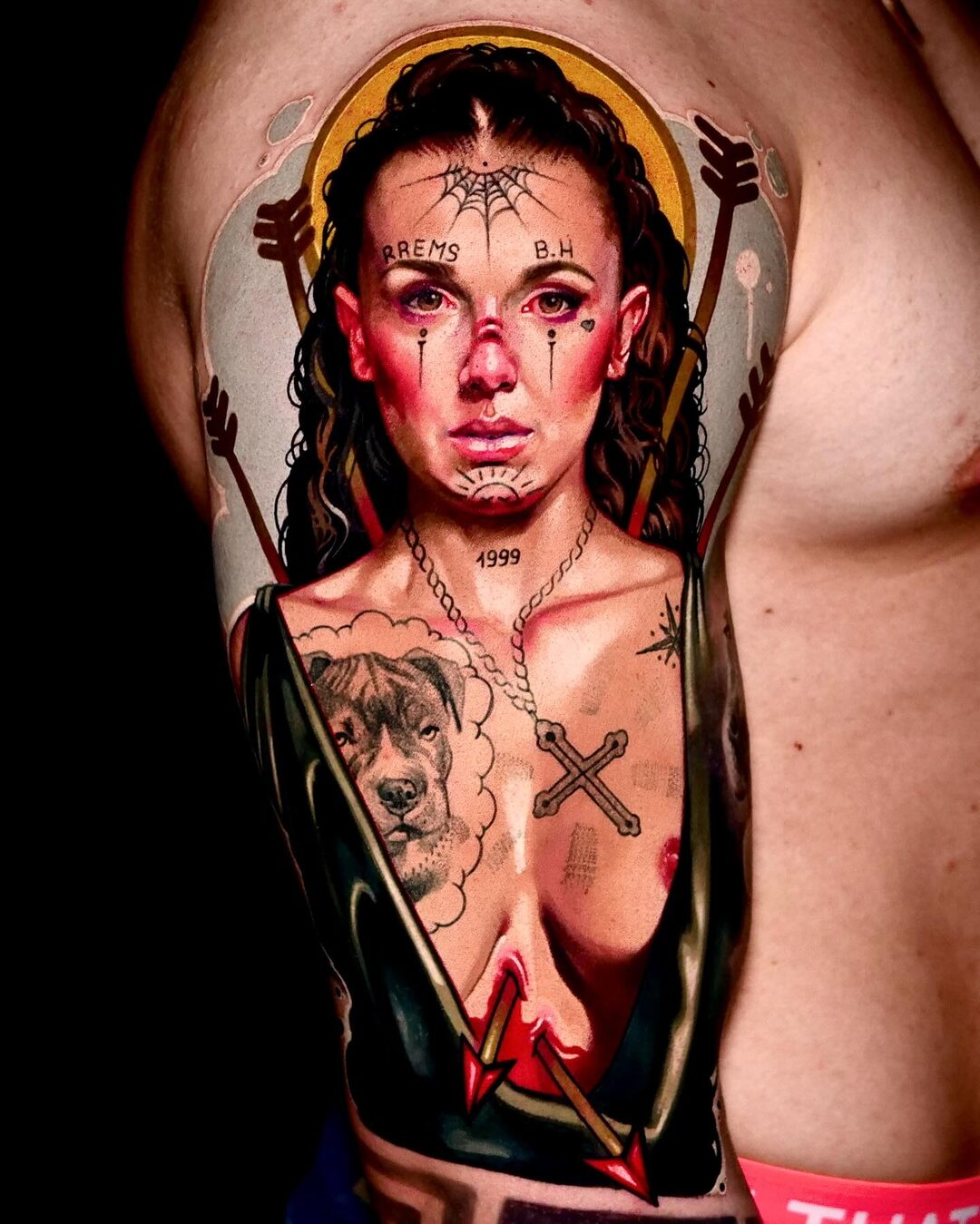 Color realism portrait tattoo of a woman with a golden halo