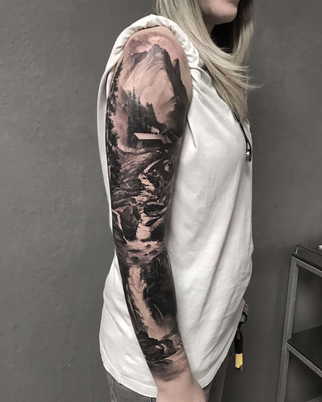 Black-and-grey realism tattoo sleeve on the forearm