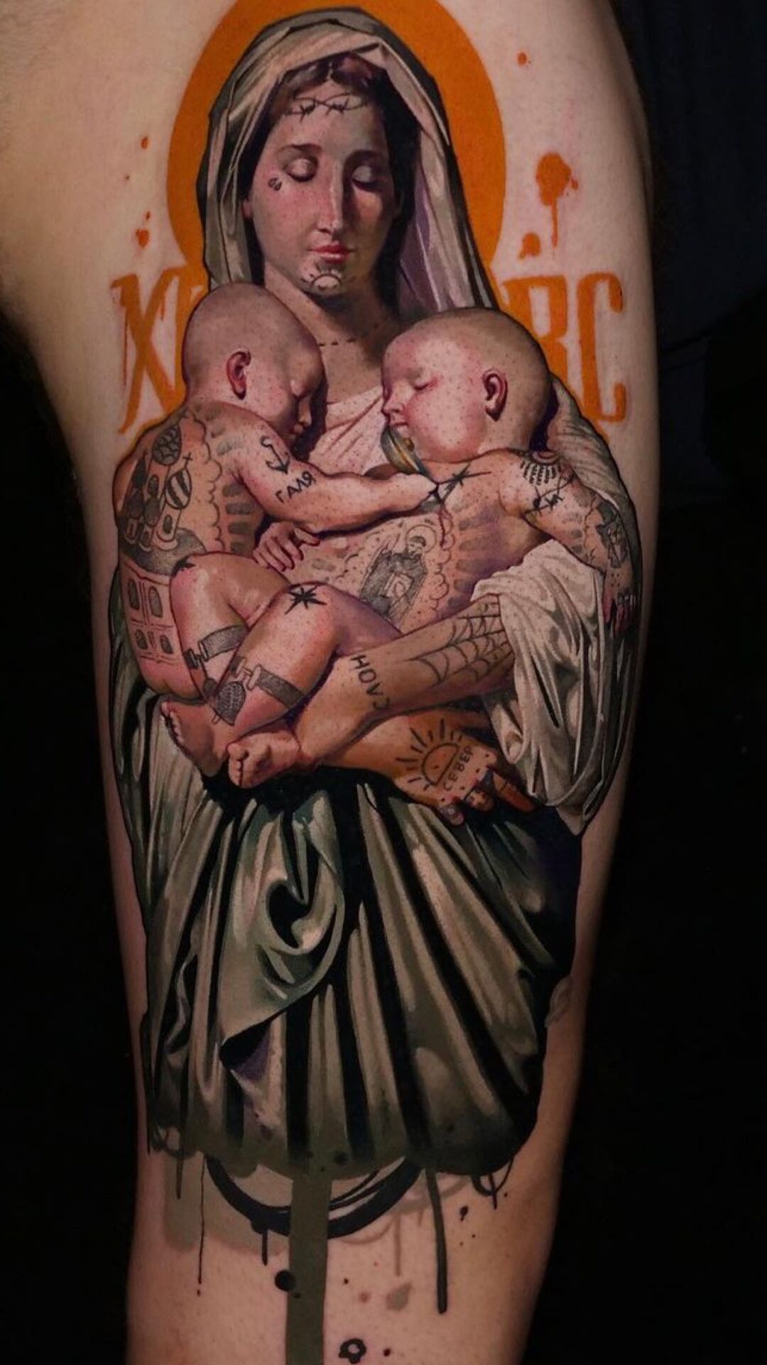 Color realism religious tattoo of the Madonna and child